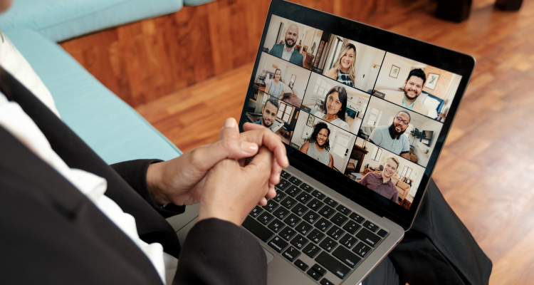 Open laptop displaying a group of individuals in a virtual meeting