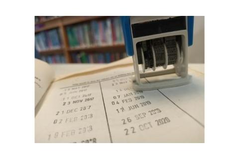 Photo of library book with due date stamp.